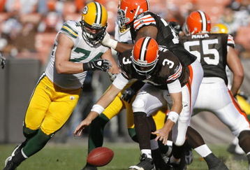 CLEVELAND, OH - OCTOBER 25:  Derek Anderson #3 of the Cleveland Browns fights for a fumble with Aaron Kampman #74 the Green Bay Packers at Cleveland Browns at Cleveland Browns Stadium on October 25, 2009 in Cleveland, Ohio.  (Photo by Matt Sullivan/Getty Images)