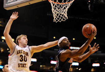 LOS ANGELES, CA - MARCH 12:  Guard Nic Wise #13 of the Arizona Wildcats takes a shot as  Rihards Kuksiks #30 of the Arizona State Sun Devils defends during the Pacific Life Pac-10 Men's Basketball Tournament at the Staples Center on March 12, 2009 in Los Angeles, California.  (Photo by Harry How/Getty Images)