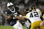 STATE COLLEGE, PA - SEPTEMBER 26:  Daryll Clark #17 of the Penn State Nittnay Lions is tackled by Karl Klug #95 and Jeremiha Hunter #42 of the Iowa Hawkeye's on September 26, 2009 at Beaver Stadium in State College, Pennsylvania.  (Photo by Gregory Shamus/Getty Images)