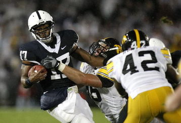 STATE COLLEGE, PA - SEPTEMBER 26:  Daryll Clark #17 of the Penn State Nittnay Lions is tackled by Karl Klug #95 and Jeremiha Hunter #42 of the Iowa Hawkeye's on September 26, 2009 at Beaver Stadium in State College, Pennsylvania.  (Photo by Gregory Shamus/Getty Images)
