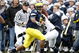 ANN ARBOR, MI - OCTOBER 24: Martavious Odoms #9 of the Michigan Wolverines tries to get around the tackle of Nick Sukay #18 of the Penn State Nittany Lions on October 24, 2009 at Michigan Stadium in Ann Arbor, Michigan. Penn State won the game 35-10. (Photo by Gregory Shamus/Getty Images)