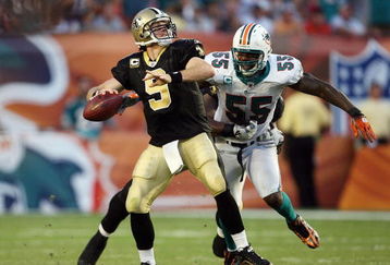 MIAMI - OCTOBER 25:  Quarterback Drew Brees #9 of the New Orleans Saints throws a pass before being hit by linebacker Joey Porter #55 of the Miami Dolphins at Land Shark Stadium on October 25, 2009 in Miami, Florida. The Saints defeated the Dolphins 46-34.  (Photo by Doug Benc/Getty Images)