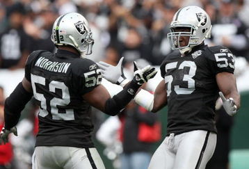 OAKLAND, CA - OCTOBER 18:  Thomas Howard #53 and Kirk Morrison #52 of the Oakland Raiders celebrate after a play against the Philadelphia Eagles during an NFL game at the Oakland-Alameda County Coliseum on October 18, 2009 in Oakland, California.  (Photo by Jed Jacobsohn/Getty Images)
