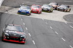 MARTINSVILLE, VA - OCTOBER 25:  Denny Hamlin, driver of the #11 FedEx Freight Toyota, leads Jimmie Johnson, driver of the #48 Lowe's Chevrolet, and Juan Pablo Montoya, driver of the #42 Target Chevrolet, during the final laps of the NASCAR Sprint Cup Series TUMS Fast Relief 500 at Martinsville Speedway on October 25, 2009 in Martinsville, Virginia.  (Photo by Streeter Lecka/Getty Images)