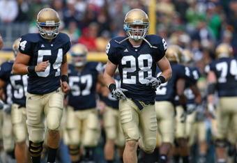 SOUTH BEND, IN - OCTOBER 03: Kyle McCarthy #28 and Anthony McDonald #54 of the Notre Dame Fighting Irish run onto the field with teammates before a game against the Washington Huskies on October 3, 2009 at Notre Dame Stadium in South Bend, Indiana. Notre Dame defeated Washington 37-30 in overtime.  (Photo by Jonathan Daniel/Getty Images)