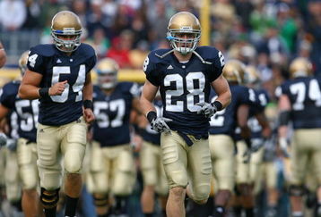 SOUTH BEND, IN - OCTOBER 03: Kyle McCarthy #28 and Anthony McDonald #54 of the Notre Dame Fighting Irish run onto the field with teammates before a game against the Washington Huskies on October 3, 2009 at Notre Dame Stadium in South Bend, Indiana. Notre Dame defeated Washington 37-30 in overtime.  (Photo by Jonathan Daniel/Getty Images)