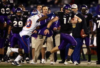 SAN DIEGO, CA - DECEMBER 23:  Quarterback Andy Dalton #14 of  TCU runs with the ball against the tackle of Safety Jeron Johnson #23 of Boise State during the San Diego County Credit Union Poinsettia Bowl at Qualcomm Stadium on December 23, 2008 in San Diego, California. (Photo by Donald Miralle/Getty Images)