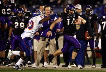 SAN DIEGO, CA - DECEMBER 23:  Quarterback Andy Dalton #14 of  TCU runs with the ball against the tackle of Safety Jeron Johnson #23 of Boise State during the San Diego County Credit Union Poinsettia Bowl at Qualcomm Stadium on December 23, 2008 in San Diego, California. (Photo by Donald Miralle/Getty Images)