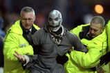 6 Nov 1999:  Halloween intruder is led away by stewards during the FA Carling Premiership match between Sheffield Wednesday and Watford at Hillsborough in Sheffield, England. \ Mandatory Credit: Mark Thompson /Allsport