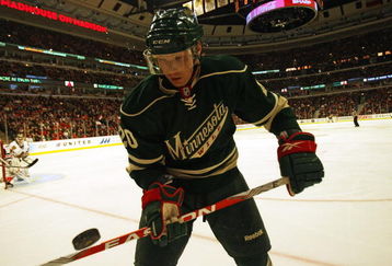 CHICAGO - OCTOBER 26: Antti Miettinen #20 of the Minnesota Wild flips the puck off of his stick in the corner against the Chicago Blackhawks at the United Center on October 26, 2009 in Chicago, Illinois. (Photo by Jonathan Daniel/Getty Images)