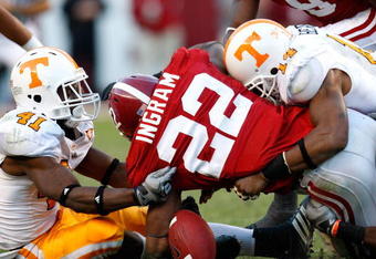 TUSCALOOSA, AL - OCTOBER 24:  Dennis Rogan #41 and Eric Berry #14 of the Tennessee Volunteers force a fumble by Mark Ingram #22 of the Alabama Crimson Tide at Bryant-Denny Stadium on October 24, 2009 in Tuscaloosa, Alabama.  (Photo by Kevin C. Cox/Getty Images)