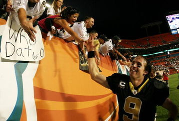 MIAMI - OCTOBER 25:  Quarterback Drew Brees #9 of the New Orleans Saints celebrates with Saints' fans after his team's victory over the Miami Dolphins at Land Shark Stadium on October 25, 2009 in Miami, Florida. The Saints defeated the Dolphins 46-34.  (Photo by Doug Benc/Getty Images)