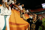 MIAMI - OCTOBER 25:  Quarterback Drew Brees #9 of the New Orleans Saints celebrates with Saints' fans after his team's victory over the Miami Dolphins at Land Shark Stadium on October 25, 2009 in Miami, Florida. The Saints defeated the Dolphins 46-34.  (Photo by Doug Benc/Getty Images)