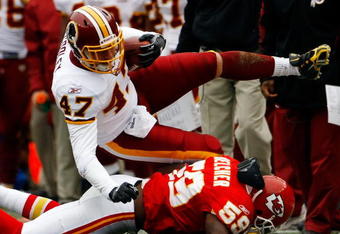 LANDOVER, MD - OCTOBER 18: Tight end Chris Cooley #47 of the Washington Redskins is tackled by Derrick Johnson #58 of the Kansas City Chiefs during their game October 18, 2009 at FedEx Field in Landover, Maryland. Kansas City kicker Ryan Succop had 4 field goals as the Chiefs won the game 14-6.  (Photo by Win McNamee/Getty Images)