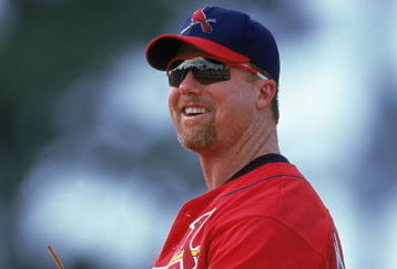 12 Mar 2000: Mark McGwire #25 of the St. Louis Cardinals smiles as he stands in the field during a Spring Training Game against the Los Angeles Dodgers at the Holman Stadium in Vero Beach, Florida. The Cardinals defeated the Dodgers 7-5. Mandatory Credit: Harry How  /Allsport