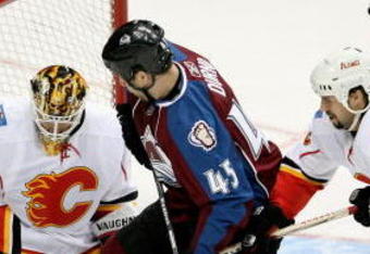 DENVER - JANUARY 18: Goaltender Curtis McElhinney #1 of the Calgary Flames turns away the puck as Adrian Aucoin #33 helps defend against Chris Durno #45 of the Colorado Avalanche during NHL action at the Pepsi Center on January 18, 2009 in Denver, Colorado. (Photo by Doug Pensinger/Getty Images)