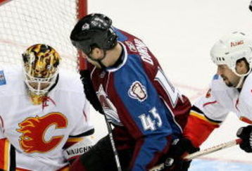 DENVER - JANUARY 18: Goaltender Curtis McElhinney #1 of the Calgary Flames turns away the puck as Adrian Aucoin #33 helps defend against Chris Durno #45 of the Colorado Avalanche during NHL action at the Pepsi Center on January 18, 2009 in Denver, Colorado. (Photo by Doug Pensinger/Getty Images)