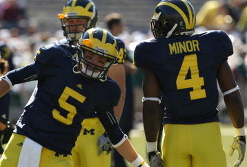 ANN ARBOR, MI - SEPTEMBER 19:  Quarterback Tate Forcier #5 of the Michigan Wolverines greets running back Brandon Minor #4 during warmups for the game against the Eastern Michigan Eagles at Michigan Stadium on September 19, 2009 in Ann Arbor, Michigan.  Michigan won 45-17.  (Photo by Stephen Dunn/Getty Images)
