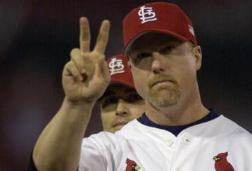 ST. LOUIS - OCTOBER 12:  Mark McGwire #25 of the St.Louis Cardinals salutes the crowd during team introductions before Game three of the National League Division Series against the Arizona Diamondbacks on October 12, 2001 at Busch Stadium in St. Louis, Missouri. The Diamondbacks won 5-3.  (Photo by Elsa/Getty Images)