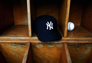 TAMPA, FL - FEBRUARY 25:  A New York Yankees cap and a baseball are seen at Legends Field on February 25, 2005 in Tampa, Florida. (Photo by Ezra Shaw/Getty Images)