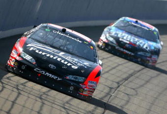 FONTANA, CA - OCTOBER 10:  Kyle Busch, driver of the #18 Z-Line Designs Toyota, leads Joey Logano, driver of the #20 Gamestop Toyota, during the NASCAR Nationwide Series Copart 300 at Auto Club Speedway on October 10, 2009 in Fontana, California.  (Photo by Jason Smith/Getty Images for NASCAR)
