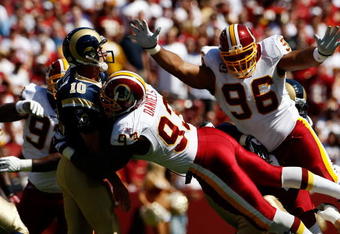 LANDOVER, MD - SEPTEMBER 20:  Mark Bulger #10 of the St. Louis Rams tries to avoid Phillip Daniels #92 and Cornelius Griffin #96 of the Washington Redskins during their game on September 20, 2009 at FedEx Field in Landover, Maryland.  (Photo by Win McNamee/Getty Images)