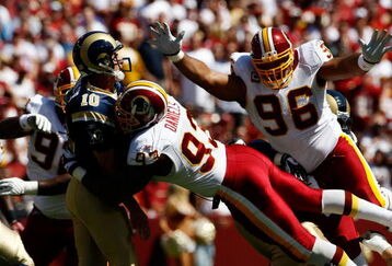 LANDOVER, MD - SEPTEMBER 20:  Mark Bulger #10 of the St. Louis Rams tries to avoid Phillip Daniels #92 and Cornelius Griffin #96 of the Washington Redskins during their game on September 20, 2009 at FedEx Field in Landover, Maryland.  (Photo by Win McNamee/Getty Images)