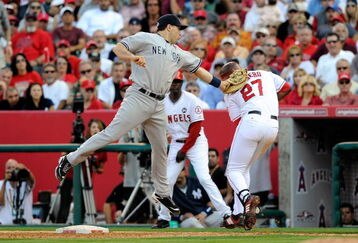 ANAHEIM, CA - OCTOBER 19:  Mark Teixeira #25 of the New York Yankees tags out Vladimir Guerrero #27 of the Los Angeles Angels of Anaheim ending the eigth inning in Game Three of the ALCS during the 2009 MLB Playoffs at Angel Stadium on October 19, 2009 in Anaheim, California.  (Photo by Kevork Djansezian/Getty Images)