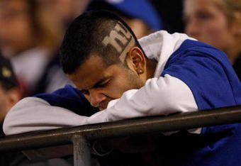 EAST RUTHERFORD, NJ - OCTOBER 25: A New York Giants fan leans over a rail during the game against the Arizona Cardinals on October 25, 2009 at Giants Stadium in East Rutherford, New Jersey. (Photo by Jared Wickerham/Getty Images)