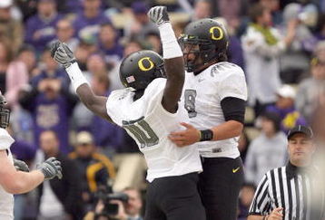 SEATTLE - OCTOBER 24:  Wide reciever D.J. Davis #10 and quarterback Jeremiah Masoli #8 of the Oregon Ducks celebrates the touchdown during the game against the Washington Huskies on October 24, 2009 at Husky Stadium in Seattle, Washington. The Ducks defeated the Huskies 43-19. (Photo by Otto Greule Jr/Getty Images)