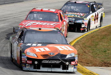 MARTINSVILLE, VA - OCTOBER 25:   Kyle Busch, driver of the #18 M&M's/Halloween Toyota, leads Kasey Kahne, driver of the #9 Budweiser Dodge, and AJ Allmendinger, driver of the #44 Colemans Natural Foods Dodge, during the NASCAR Sprint Cup Series TUMS Fast Relief 500 at Martinsville Speedway on October 25, 2009 in Martinsville, Virginia.  (Photo by John Harrelson/Getty Images)