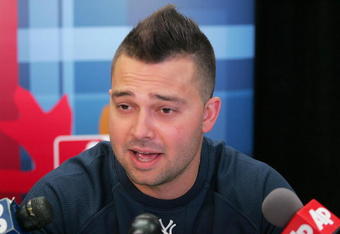 NEW YORK - OCTOBER 27: Nick Swisher #33 of the New York Yankees talks to members of the media before the World Series workouts on October 27, 2009 at Yankee Stadium in the Bronx borough of New York City.  (Photo by Jared Wickerham/Getty Images)