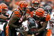 CINCINNATI - OCTOBER 25:  Garrett Wolfe #25 of the Chicago Bears is tackled by Robert Geathers #91 and Brandon Johnson #59 of the Cincinnati Bengals during the NFL game at Paul Brown Stadium on October 25, 2009 in Cincinnati, Ohio. The Bengals won 45-10.  (Photo by Andy Lyons/Getty Images)