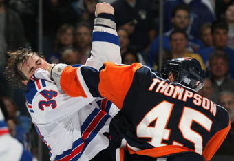 UNIONDALE, NY - OCTOBER 27: Nate Thompson #45 of the New York Islanders lands a punch on Aaron Voros #34 of the New York Rangers during their second period fight on October 27, 2008 at the Nassau Coliseum in Uniondale, New York. (Photo by Bruce Bennett/Getty Images)
