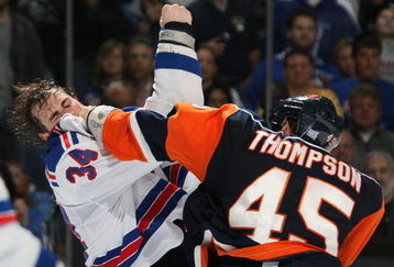 UNIONDALE, NY - OCTOBER 27: Nate Thompson #45 of the New York Islanders lands a punch on Aaron Voros #34 of the New York Rangers during their second period fight on October 27, 2008 at the Nassau Coliseum in Uniondale, New York. (Photo by Bruce Bennett/Getty Images)