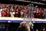 PHILADELPHIA - OCTOBER 29:  The World Series Championship trophy is held up in front of fans of the Philadelphia Phillies after they won 4-3 against the Tampa Bay Rays during the continuation of game five of the 2008 MLB World Series on October 29, 2008 at Citizens Bank Park in Philadelphia, Pennsylvania.  (Photo by Jed Jacobsohn/Getty Images)