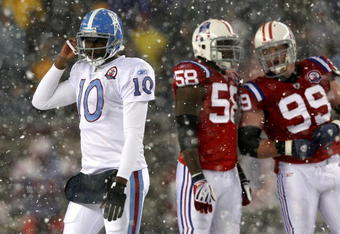 FOXBORO - OCTOBER 18:  Vince Young #10 of the Tennessee Titans leaves the field as Pierre Woods #58 and Mike Wright #99 of the New England Patriots converse at Gillette Stadium on October 18, 2009 in Foxboro, Massachusetts. The Patriots won 59-0. (Photo by Jim Rogash/Getty Images)