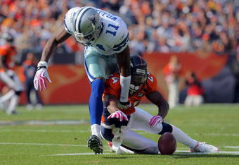 DENVER - OCTOBER 04:  Champ Bailey #24 of the Denver Broncos breaks up a pass intended for Roy Williams #11 of the Dallas Cowboys during NFL action at Invesco Field at Mile High on October 4, 2009 in Denver, Colorado. The Broncos defeated the Cowboys 17-10.  (Photo by Doug Pensinger/Getty Images)
