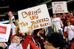 PHILADELPHIA - OCTOBER 21:  Fans of the Philadelphia Phillies hold up signs which call for the Phillies to play against the New York Yankees in the World Series after the Phillies advanced to the series with their 10-4 against the Los Angeles Dodgers in Game Five of the NLCS during the 2009 MLB Playoffs at Citizens Bank Park on October 21, 2009 in Philadelphia, Pennsylvania.  (Photo by Jeff Zelevansky/Getty Images)