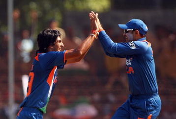 VADODARA, INDIA - OCTOBER 25:  Ishant Sharma of India celebrates with Virender Sehwag after taking the wicket of Tim Paine of Australia during the first One Day International match between India and Australia at Reliance Stadium on October 25, 2009 in Vadodara, India.  (Photo by Cameron Spencer/Getty Images)