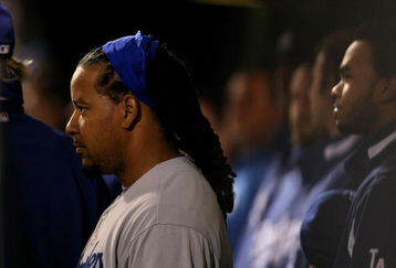 PHILADELPHIA - OCTOBER 18:  Manny Ramirez #99 of the Los Angeles Dodgers stands in the dugout during their game against the Philadelphia Phillies in Game Three of the NLCS during the 2009 MLB Playoffs at Citizens Bank Park on October 18, 2009 in Philadelphia, Pennsylvania.  (Photo by Nick Laham/Getty Images)