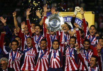 CARSON, CA - JANUARY 11:  Captain Ramon Morales #11 of CD Chivas de Guadalajara holds up the InterLiga trophy after defeating Morelia 4-2 on penalty kicks after a 1-1 draw in regulation during their InterLiga match at The Home Depot Center on January 11, 2009 in Carson, California.  (Photo by Victor Decolongon/Getty Images)