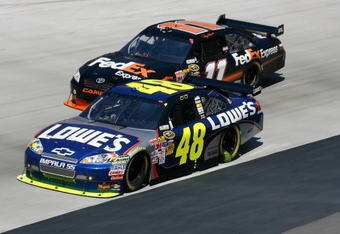 BRISTOL, TN - MARCH 22:  Denny Hamlin, driver of the #11 FedEx Express Toyota, races Jimmie Johnson, driver of the #48 Lowe's Chevrolet, side by side during the NASCAR Sprint Cup Series Food City 500 at Bristol Motor Speedway on March 22, 2009 in Bristol, Tennessee.  (Photo by Geoff Burke/Getty Images for NASCAR)