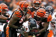 CINCINNATI - OCTOBER 25: Garrett Wolfe #25 of the Chicago Bears is tackled by Robert Geathers #91 and Brandon Johnson #59 of the Cincinnati Bengals during the NFL game at Paul Brown Stadium on October 25, 2009 in Cincinnati, Ohio. The Bengals won 45-10. (Photo by Andy Lyons/Getty Images)