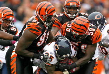 CINCINNATI - OCTOBER 25:  Garrett Wolfe #25 of the Chicago Bears is tackled by Robert Geathers #91 and Brandon Johnson #59 of the Cincinnati Bengals during the NFL game at Paul Brown Stadium on October 25, 2009 in Cincinnati, Ohio. The Bengals won 45-10.  (Photo by Andy Lyons/Getty Images)