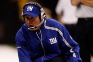 NEW ORLEANS - OCTOBER 18: Head coach Tom Coughlin of the New York Giants pulls out the red challenge flag from his sock during the game against the New Orleans Saints at the Louisiana Superdome on October 18, 2009 in New Orleans, Louisiana. (Photo by Chris Graythen/Getty Images)