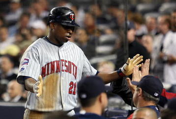 NEW YORK - OCTOBER 09:  Delmon Young #21 of the Minnesota Twins celebrates after being driven home on a triple by Brendan Harris #23 in the sixth inning against the New York Yankees in Game Two of the ALDS during the 2009 MLB Playoffs at Yankee Stadium on October 9, 2009 in the Bronx borough of New York City.  (Photo by Jim McIsaac/Getty Images)