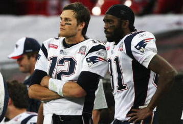 LONDON, ENGLAND - OCTOBER 25:  Tom Brady (#12) and Randy Moss (#81) of the New England Patriots look on during the NFL International Series match between New England Patriots and Tampa Bay Buccaneers at Wembley Stadium on October 25, 2009 in London, England. This is the third occasion where a regular season NFL match has been played in London.  (Photo by Elsa/Getty Images)