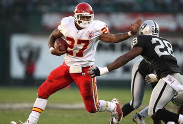 OAKLAND, CA - NOVEMBER 30:  Larry Johnson #27 of the Kansas City Chiefs runs against Gibril Wilson #28 of the Oakland Raiders during an NFL game on November 30, 2008 at the Oakland-Alameda County Coliseum in Oakland, California.  (Photo by Jed Jacobsohn/Getty Images)