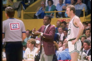1988:  Coach K.C. Jones and forward Larry Bird of the Boston Celtics talk to each other during a game at the Boston Garden in Boston, Massachusetts.    Mandatory Credit: Allsport  /Allsport
